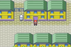 The player standing outside a row of matching green-roofed buildings.
